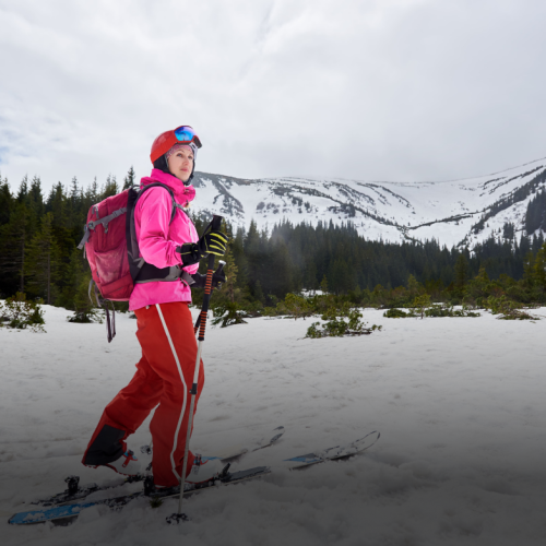 female-feet-ski-boots-backpacker-moving-ski-touring-white-sky-mountain-view-copy-space-low-angle-side-view 2